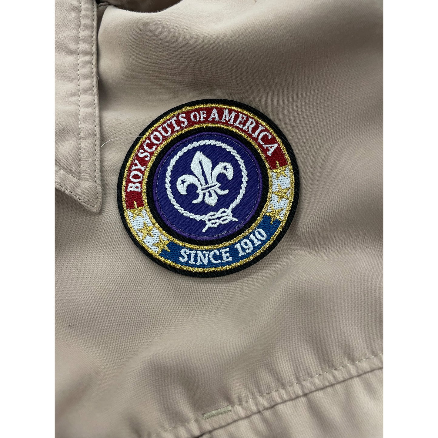 We sew patches on Scout Uniform
